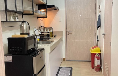 Novaliches Condo | Spacious Comfort: Two bedrooms & large living space ideal for families friends