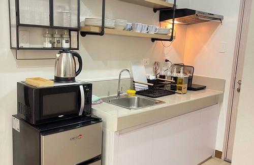 Novaliches Condo | Spacious Comfort: Two bedrooms & large living space ideal for families friends